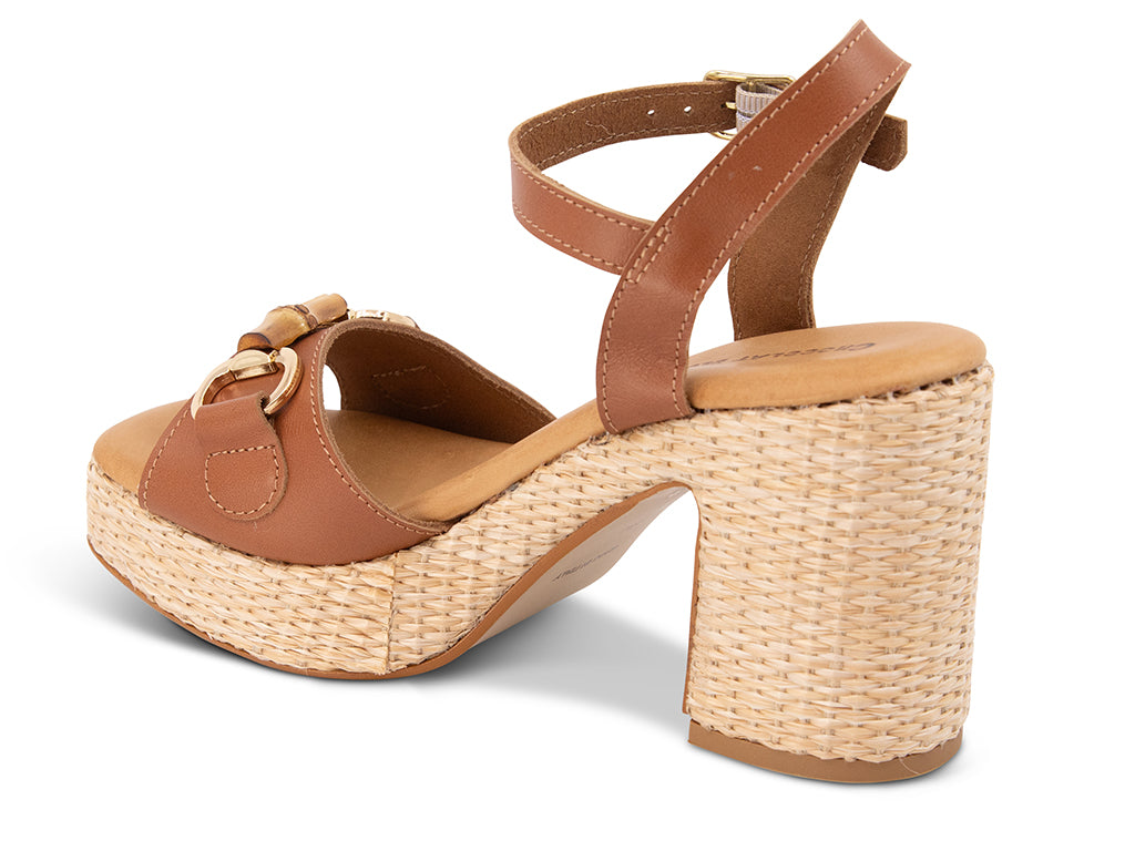 brown sandal with an ankle strap and a raffia wrapped platform - view from the back