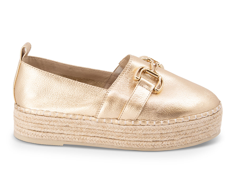 gold espadrille flat shoe with a gold buckle - side view