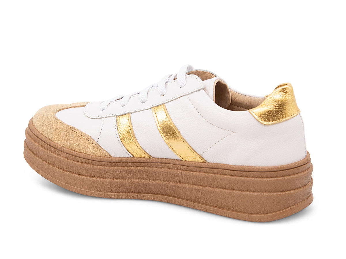 White lace up sneaker with a brown sole and gold stripe on a white background side angle view