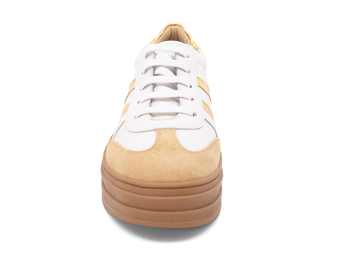 White lace up sneaker with a brown sole and gold stripe on a white background front view