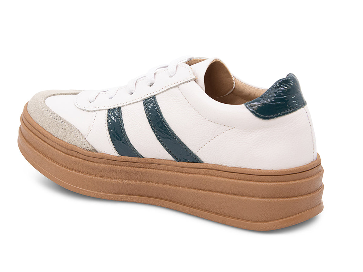 White lace up sneaker with a brown sole and green  stripe on a white background side angle view