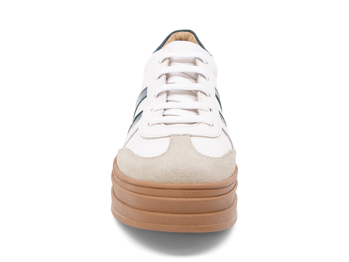 White lace up sneaker with a brown sole and green stripe on a white background front view