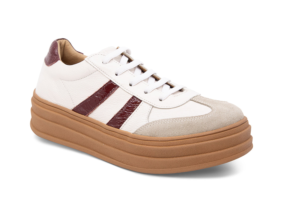 White lace up sneaker with a brown sole and burgundy stripe on a white background side angle view