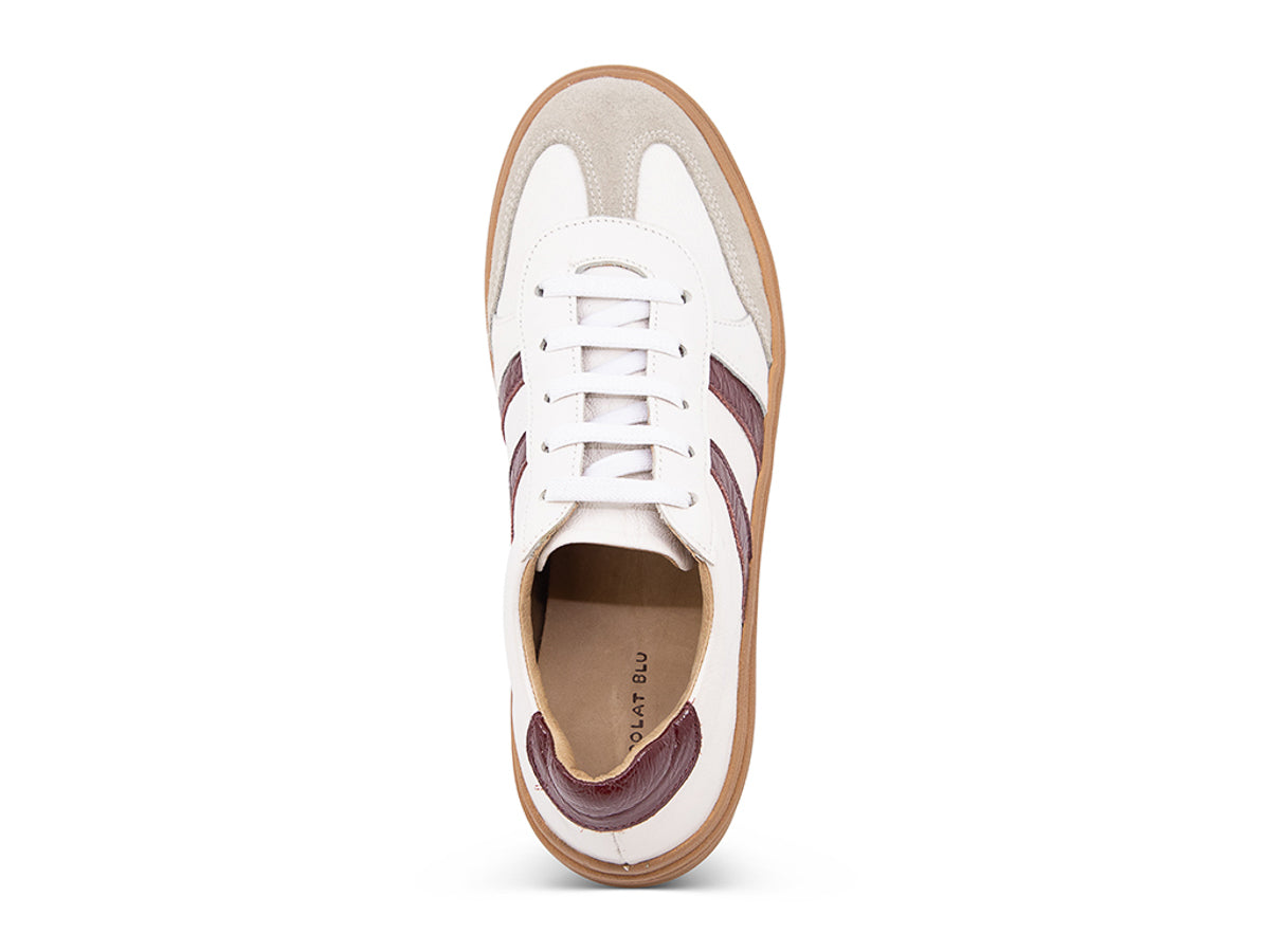 White lace up sneaker with a brown sole and burgundy stripe on a white background top view
