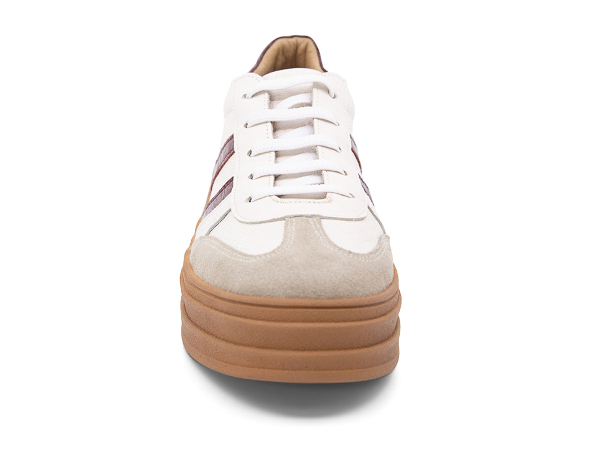 White lace up sneaker with a brown sole and burgundy stripe on a white background front view