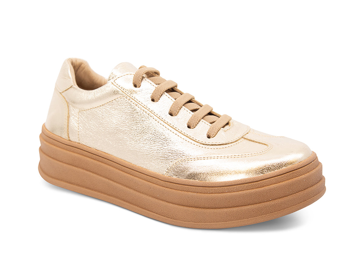 Gold lace up sneaker with a thick platform sole on a white background side angle view 