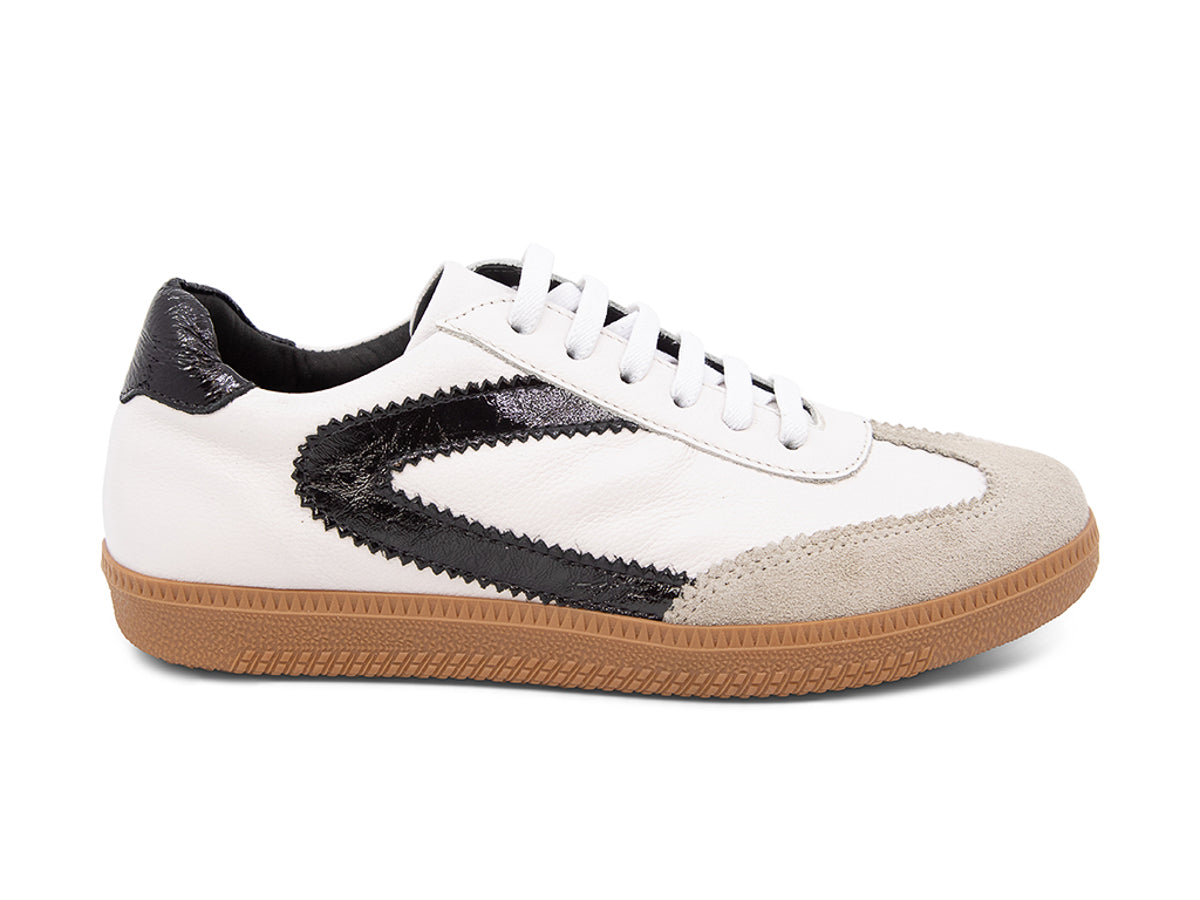 White sneaker with brown sole and black decorative design on a white background side view