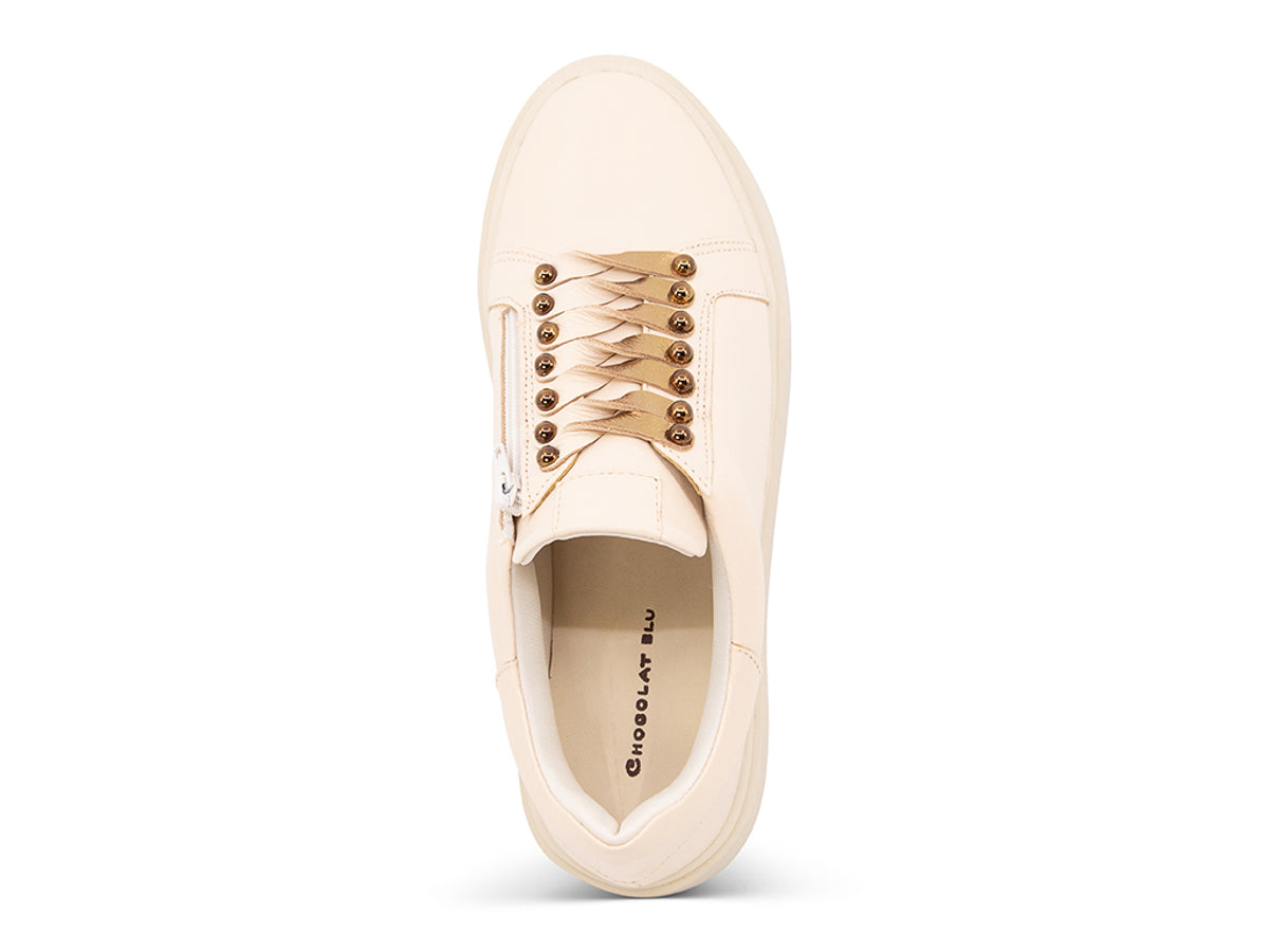 Beige sneaker with gold laces and studs on laces on a white background top