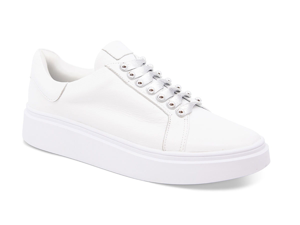 White sneaker with white laces and studs on laces on a white background side angle view