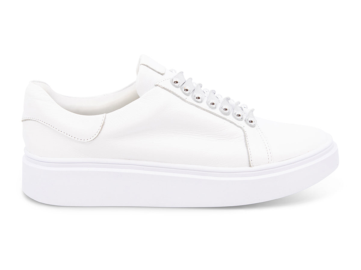 White sneaker with white laces and studs on laces on a white background side view
