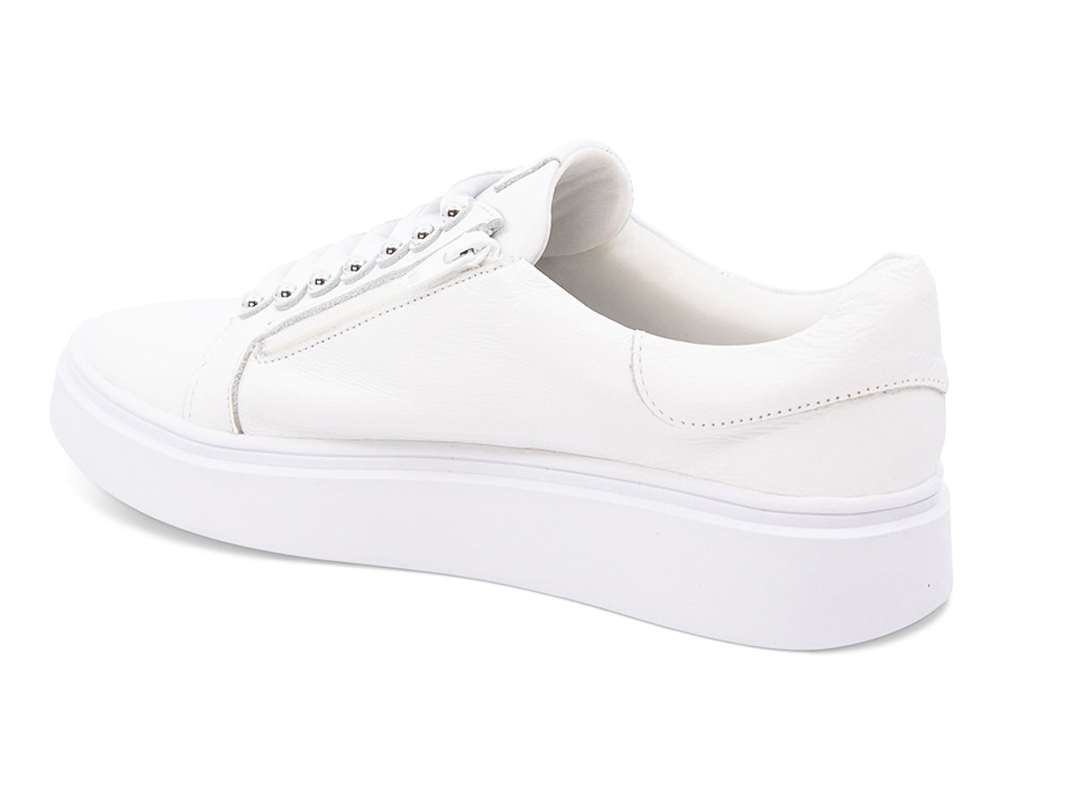 White sneaker with white laces and studs on laces on a white background side angle view