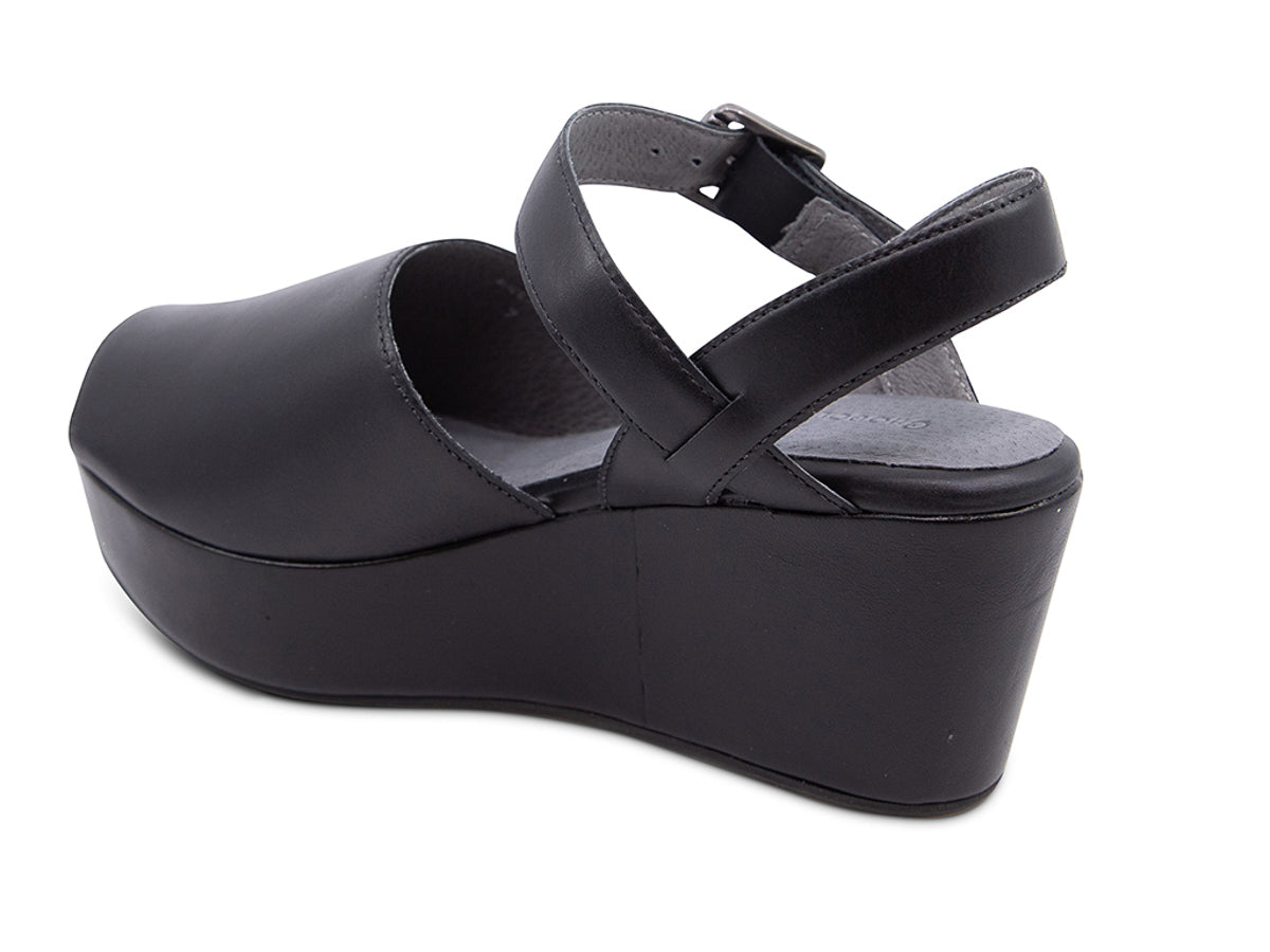 Black leather wedge peep toe platform sandal with a buckle ankle strap on a white background side angle view