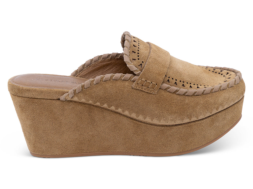 A camel suede wedge mule with decorative hand-stitched detailing and perforation -outer side view