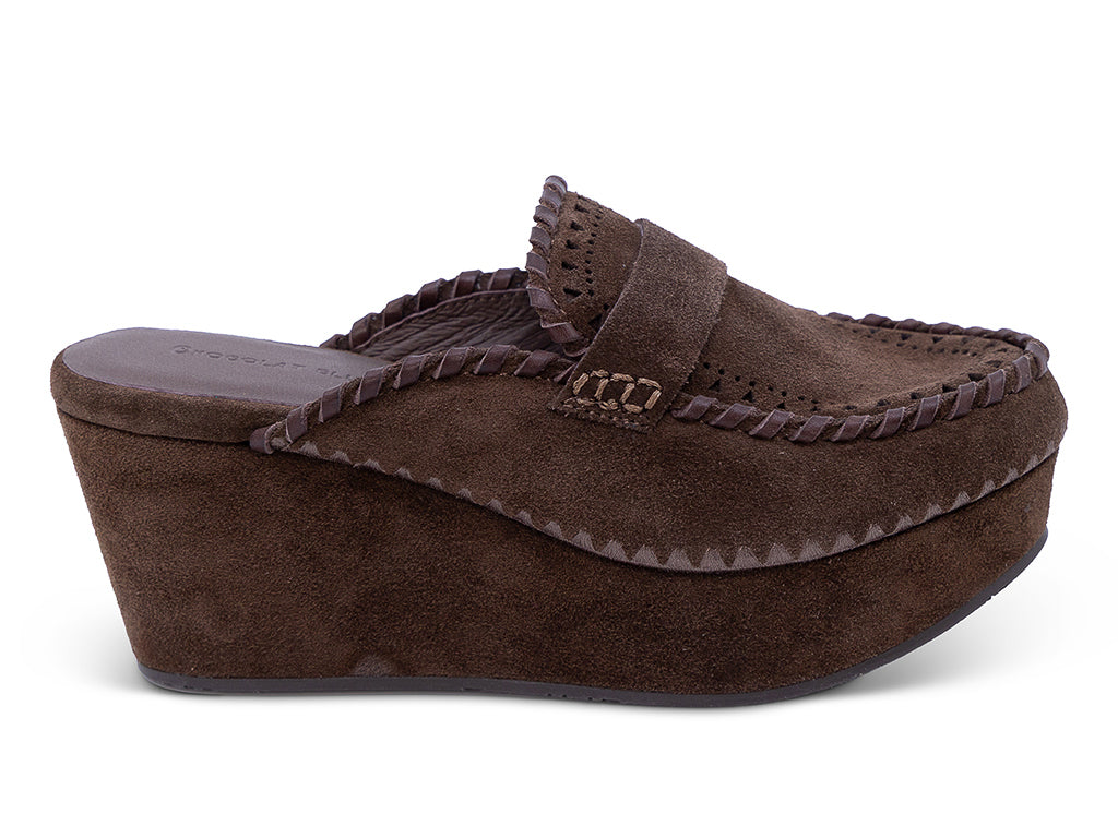 A chocolate suede wedge mule with decorative hand-stitched detailing and perforation - outer side view