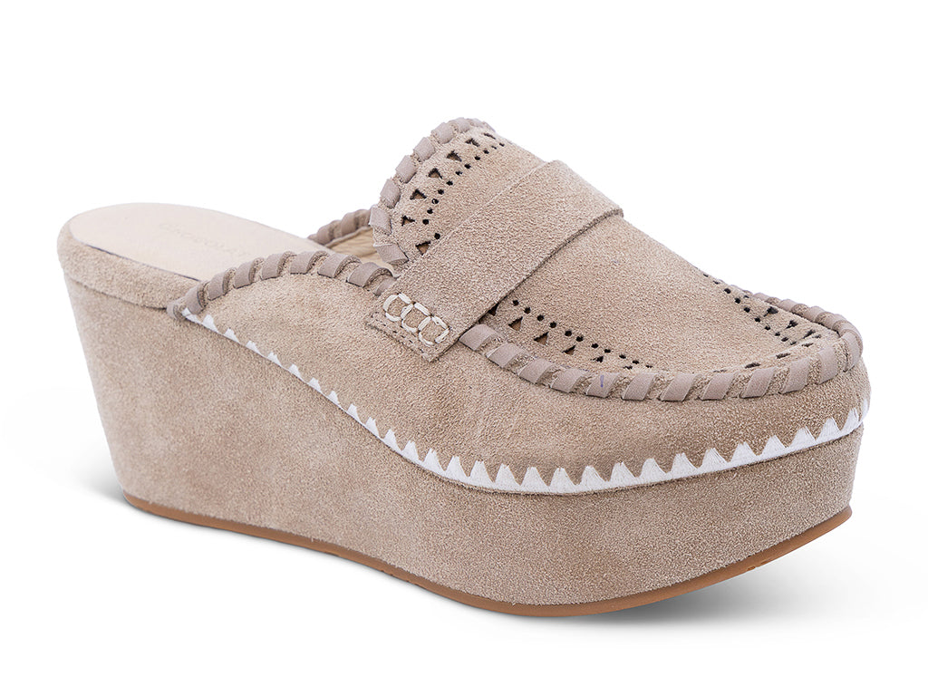 A latte suede wedge mule with decorative hand-stitched detailing and perforation - front 3/4 view