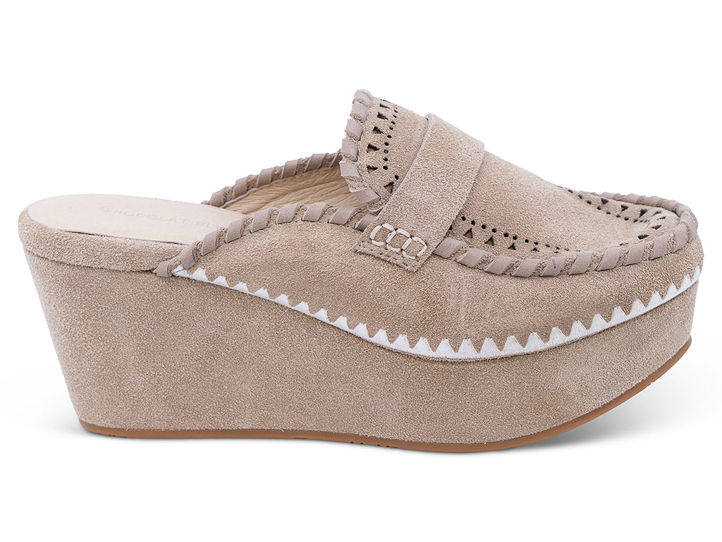 A latte suede wedge mule with decorative hand-stitched detailing and perforation - lateral side view
