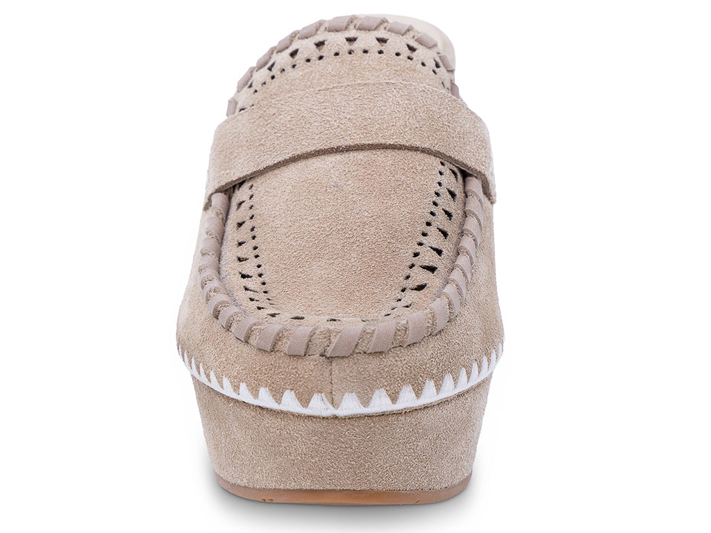 A latte suede wedge mule with decorative hand-stitched detailing and perforation - front view of the shoe shape and the upper