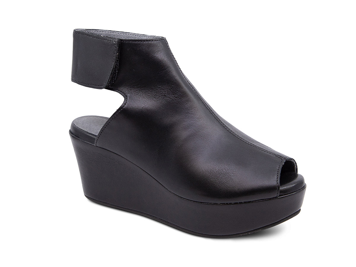 Black leather slide in peep toe wedge platform shoe with ankle velcro strap  on a white background side angle view