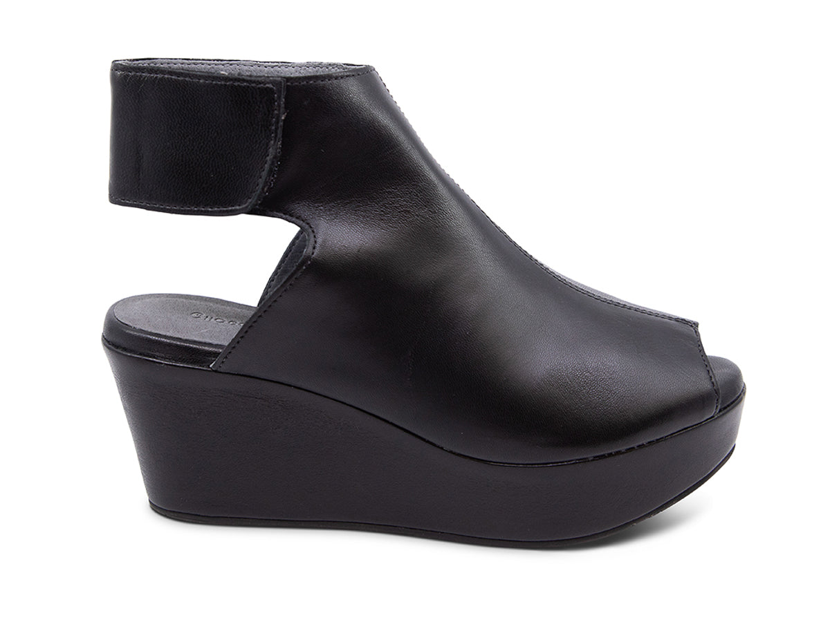 Black leather slide in peep toe wedge platform shoe with ankle velcro strap  on a white background side view