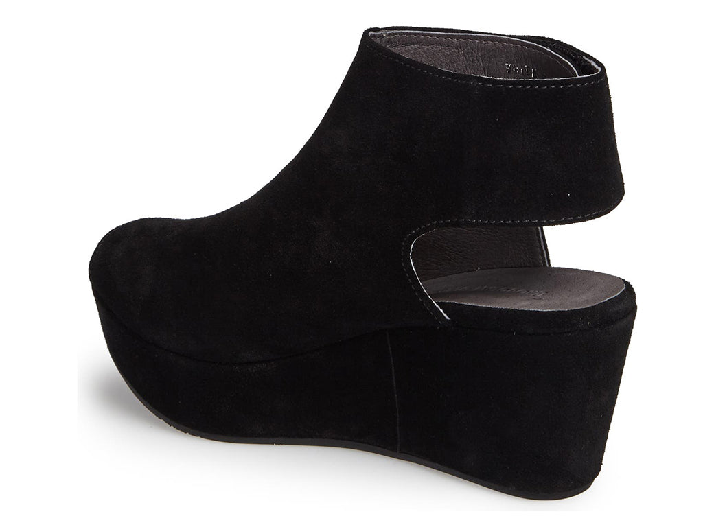 Black suede slide in peep toe wedge platform shoe with ankle velcro strap  on a white background side angle view