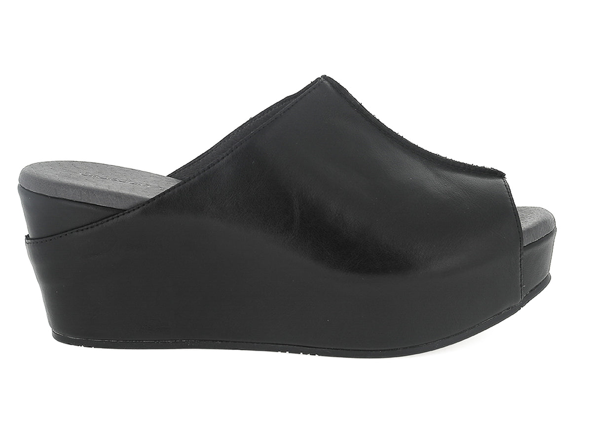 Black leather slide in peep toe wedge platform shoe with exposed seam on upper design on a white background side view
