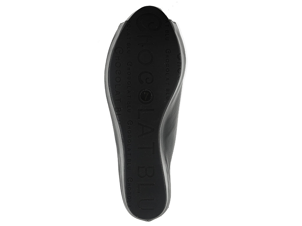 Black leather slide in peep toe wedge platform shoe with exposed seam on upper design on a white background bottom sole view