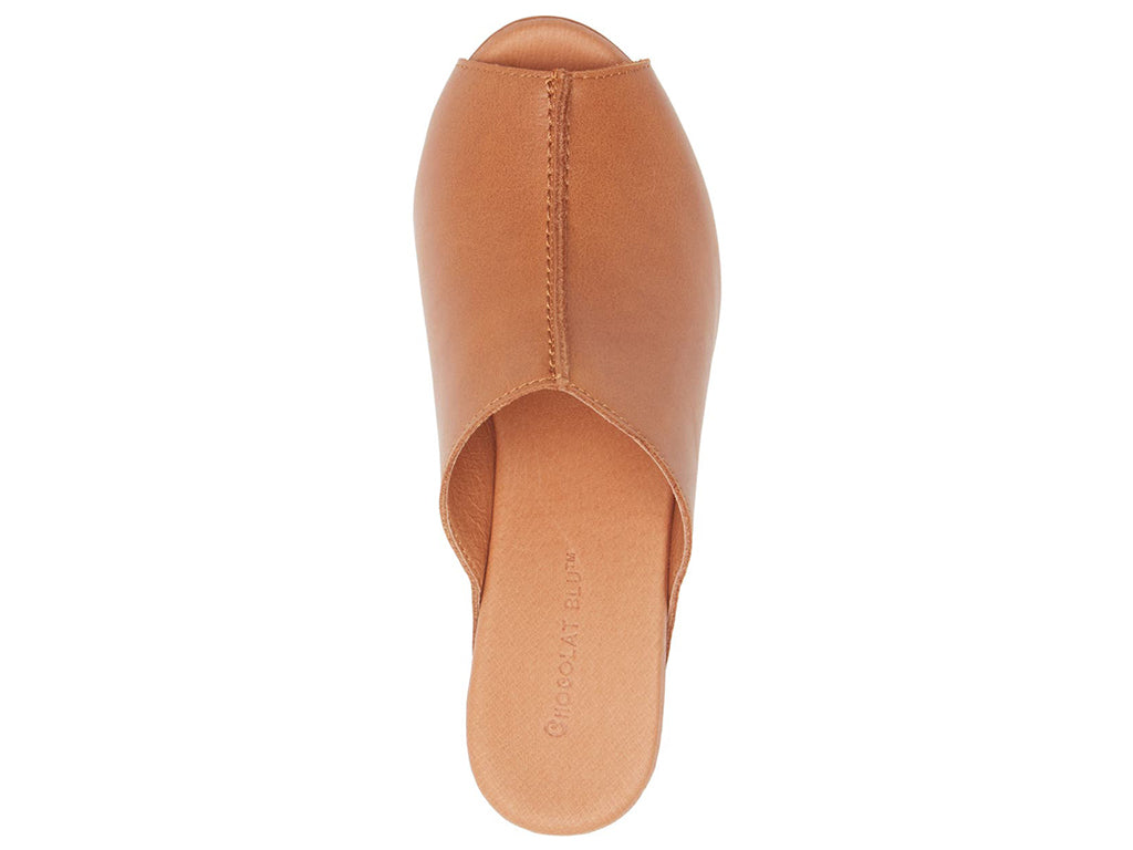 Cognac leather slide in peep toe wedge platform shoe with exposed seam on upper design on a white background top view