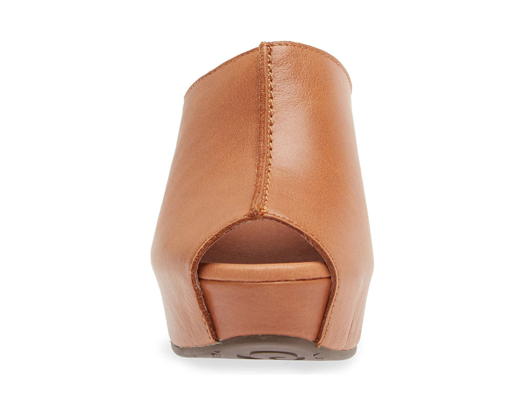 Cognac leather slide in peep toe wedge platform shoe with exposed seam on upper design on a white background front view
