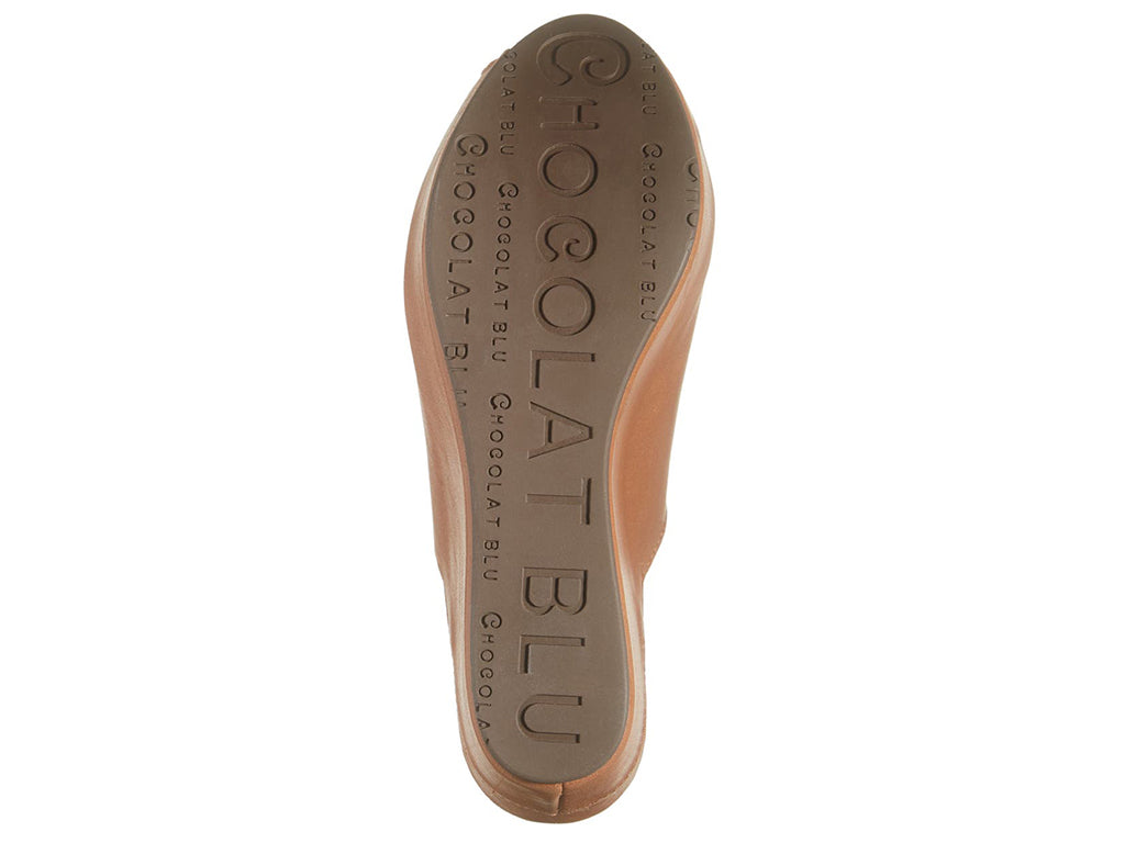 Cognac leather slide in peep toe wedge platform shoe with exposed seam on upper design on a white background bottom sole view