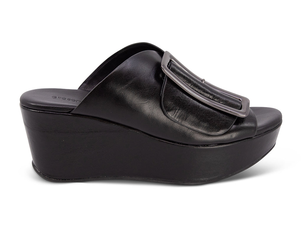 black colored wedge slide sandal with oversized silver buckle - side view