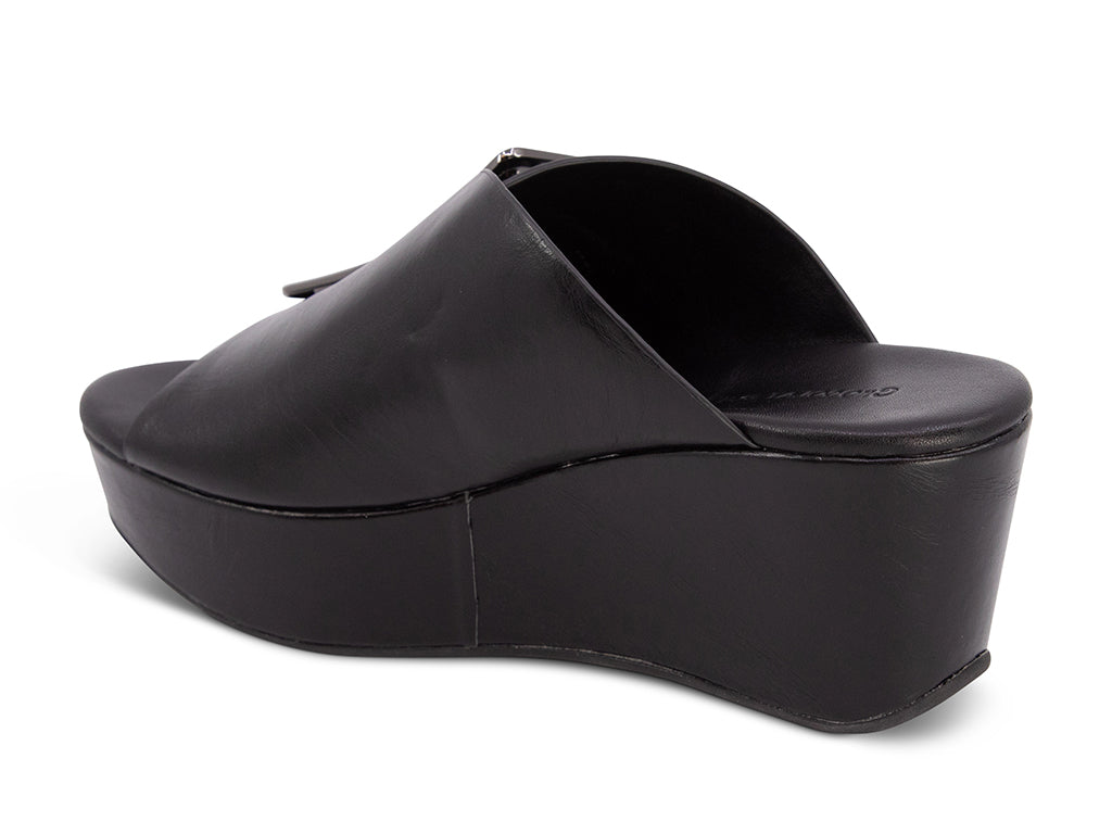black colored wedge slide sandal with oversized silver buckle - back angle view
