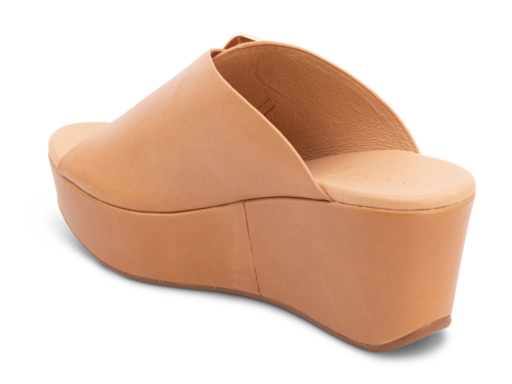 camel colored wedge slide sandal with oversized gold buckle - view from the back angle
