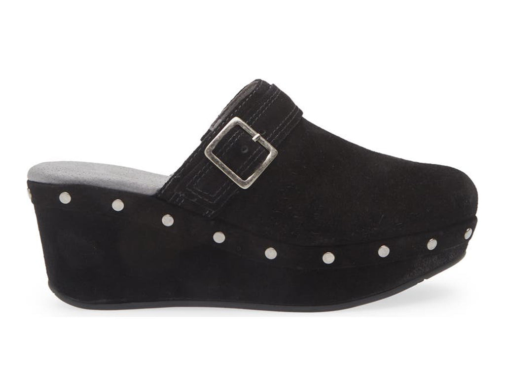 Black suede slide in clog wedge platform shoe with top strap and buckle decoration and grommet studs on a white background side view