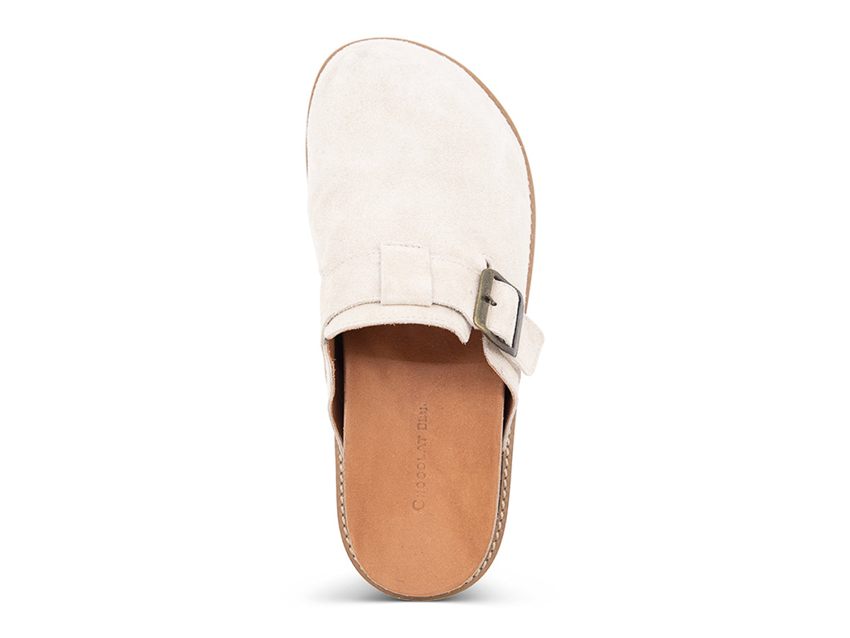 Beige slip-on shoe with a brown sole, strap and buckle on a white background top view