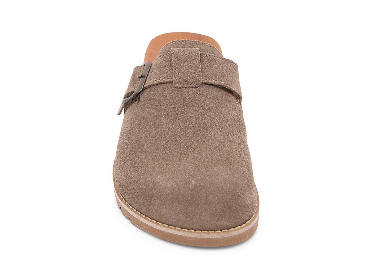 Brown slip-on shoe with a brown sole, strap and buckle on a white background front view
