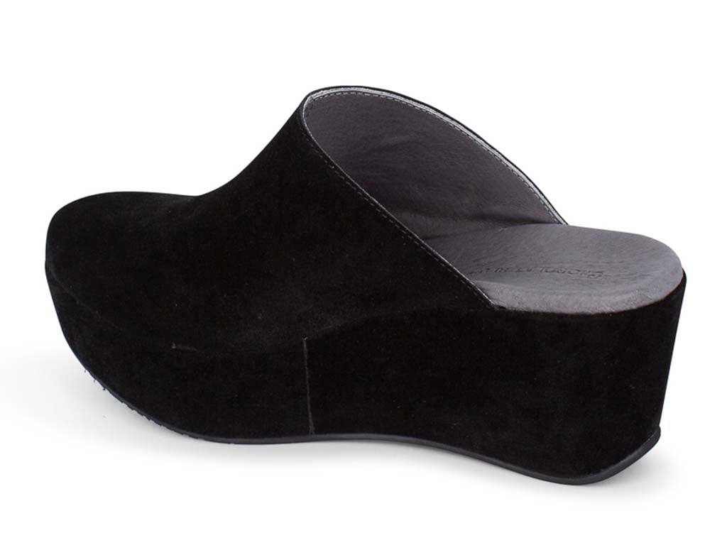 Black suede slide in wedge platform shoe on a white background side angle view