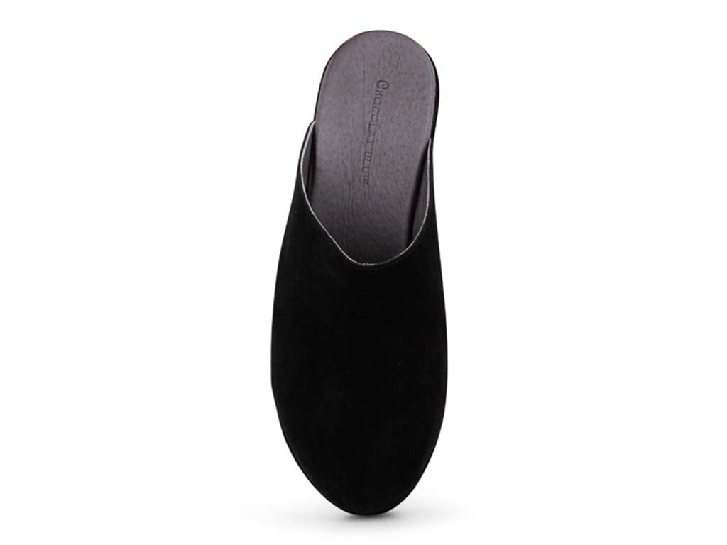 Black suede slide in wedge platform shoe on a white background top view